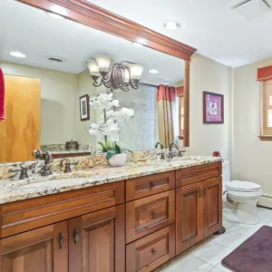 bathroom vanity that underwent home remodel with new trim and crown moulding on top of mirror 