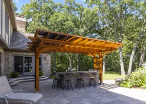 An outdoor kitchen with a pergola.