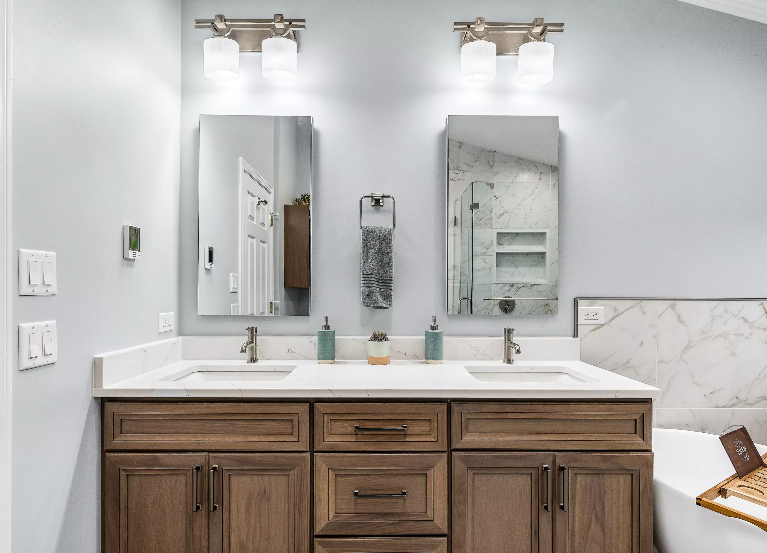 A bathroom with two sinks and two mirrors, perfect for a home renovation project.